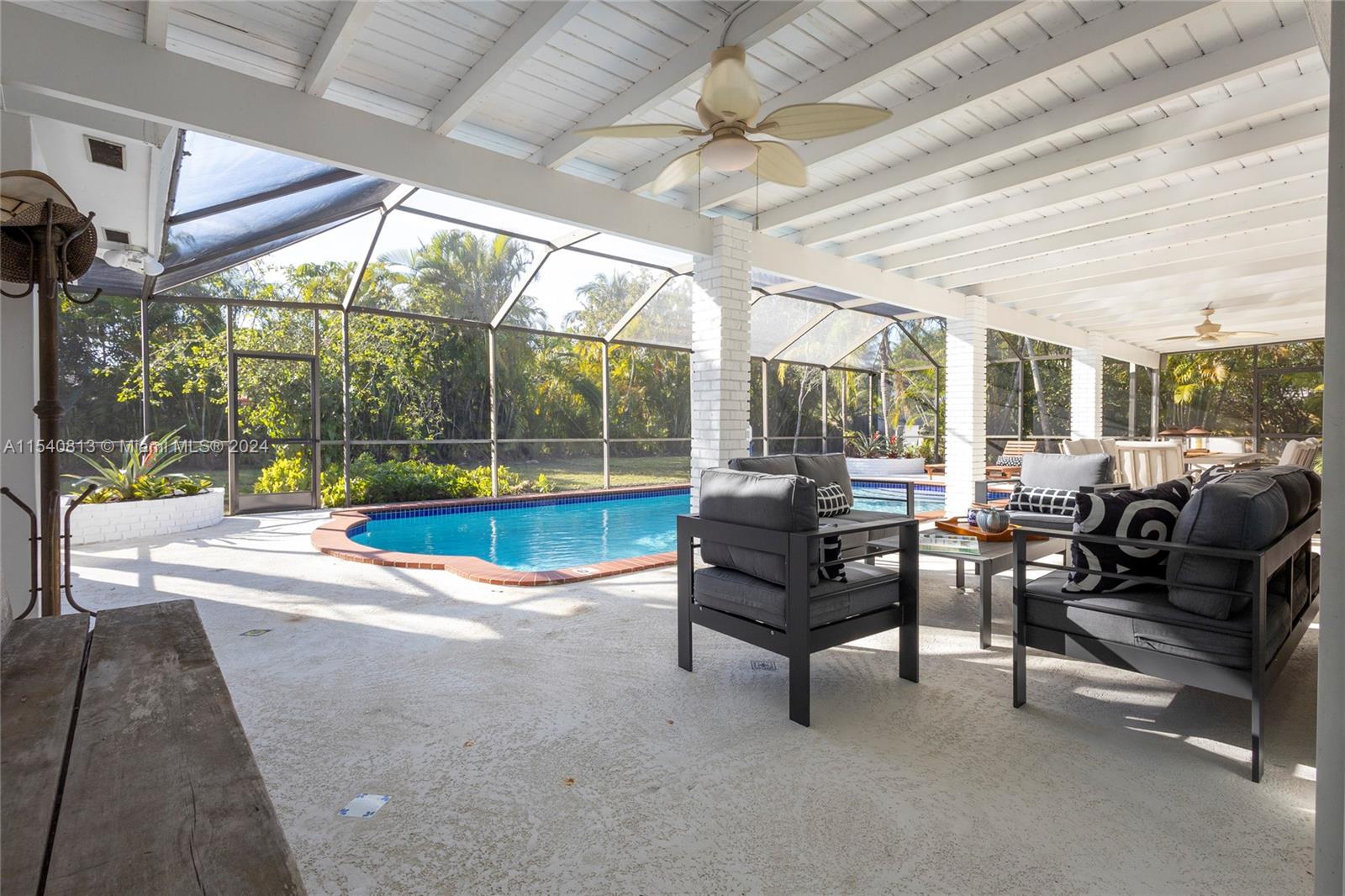 10130 Southwest 70th Avenue Pinecrest, FL 33156 - Photo 59 of 75 a living room with furniture a table and chairs