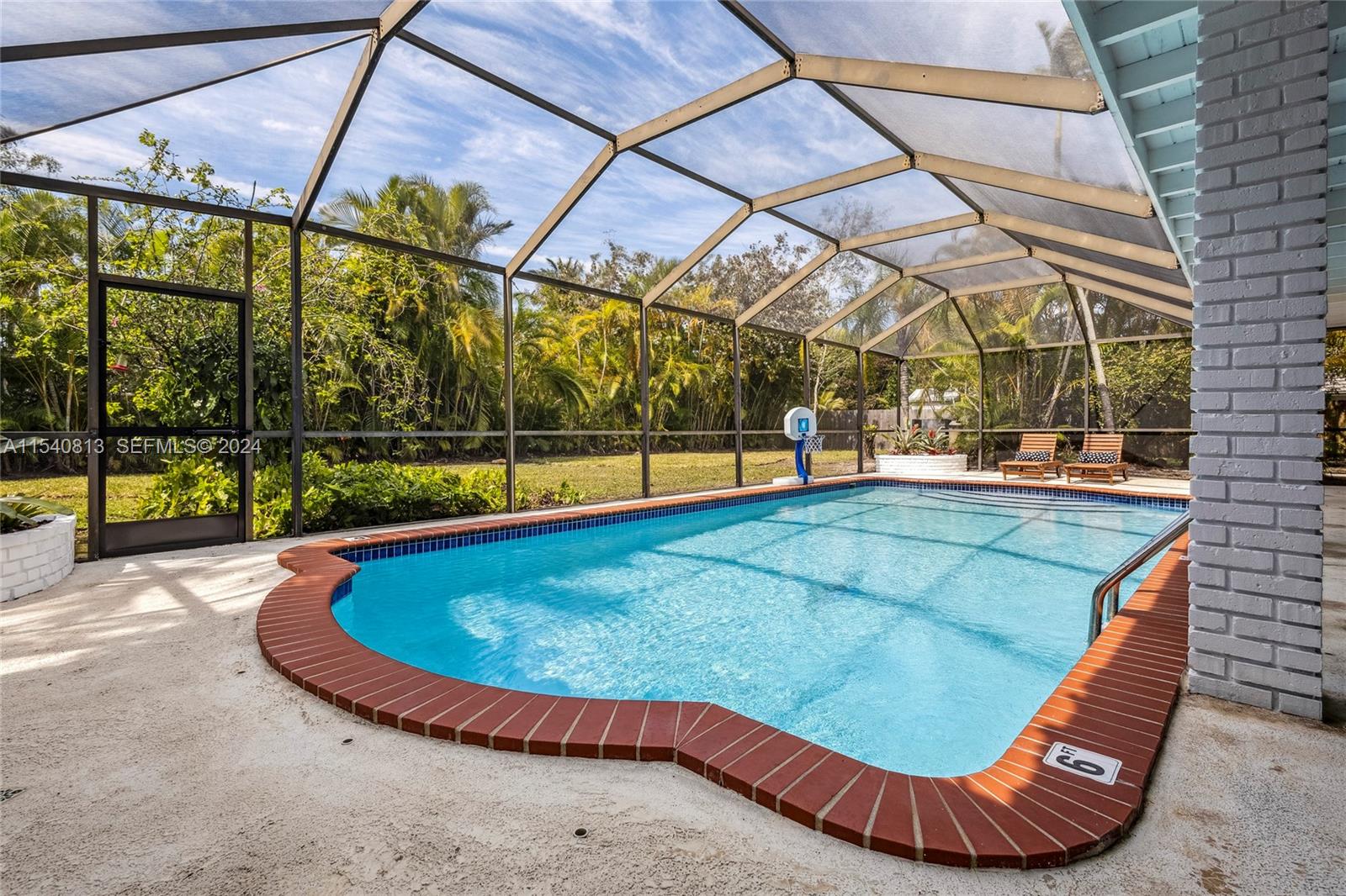 10130 Southwest 70th Avenue Pinecrest, FL 33156 - Photo 64 of 75 a view of a swimming pools under an umbrella
