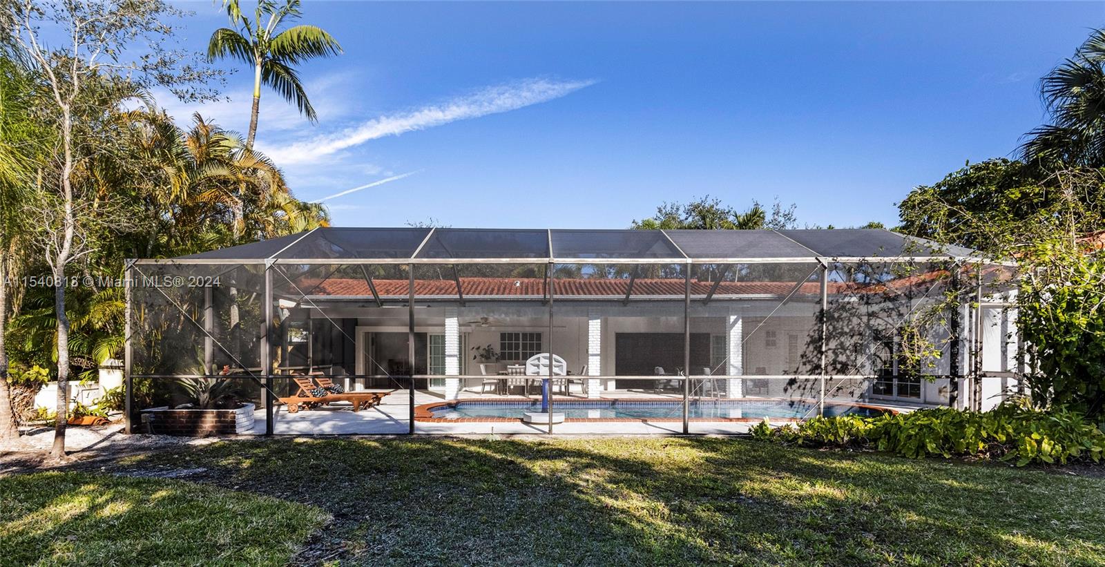 10130 Southwest 70th Avenue Pinecrest, FL 33156 - Photo 66 of 75 a view of a house with swimming pool and sitting area