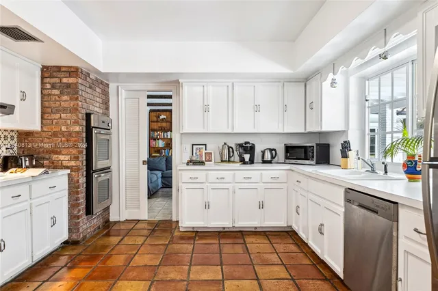 a bathroom with a toilet a sink and a large mirror
