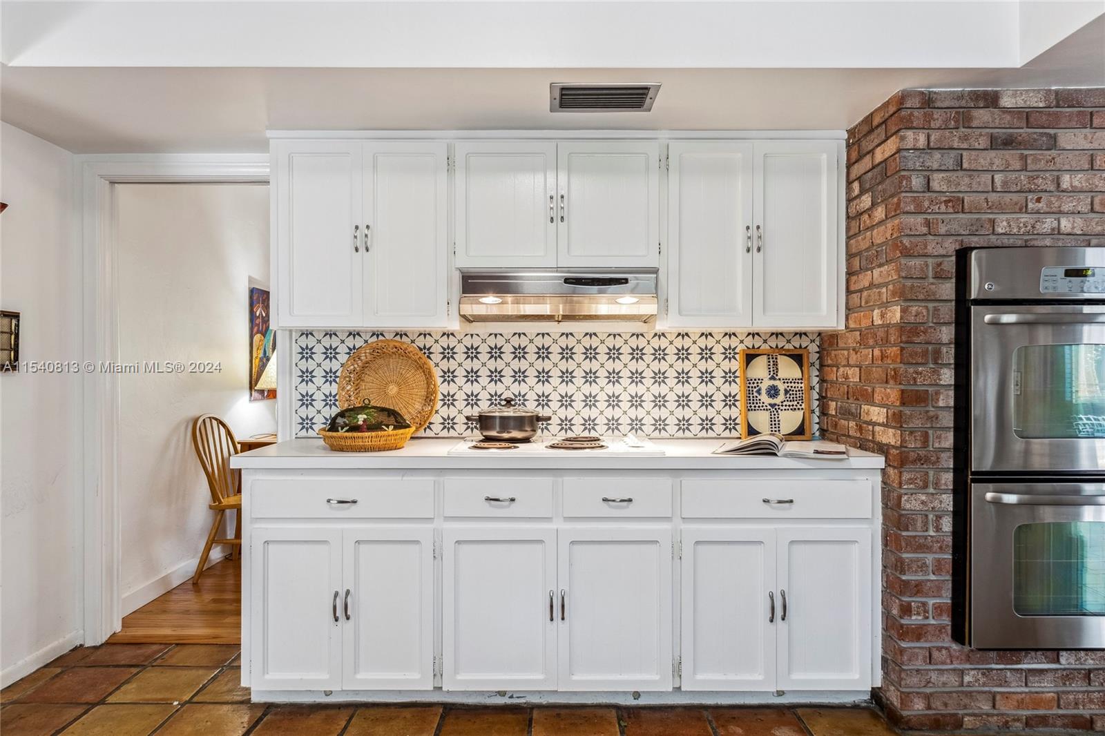 10130 Southwest 70th Avenue Pinecrest, FL 33156 - Photo 9 of 75 a kitchen with granite countertop a sink and a stove