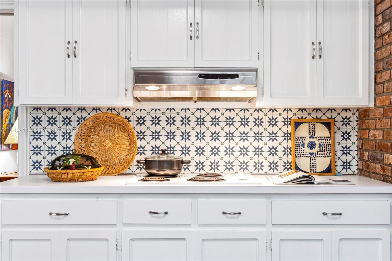 10130 Southwest 70th Avenue Pinecrest, FL 33156 - Photo 10 of 75 a bathroom with a sink and cabinets