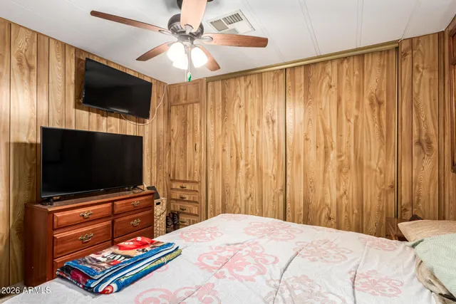 a bedroom with a bed and a flat screen tv