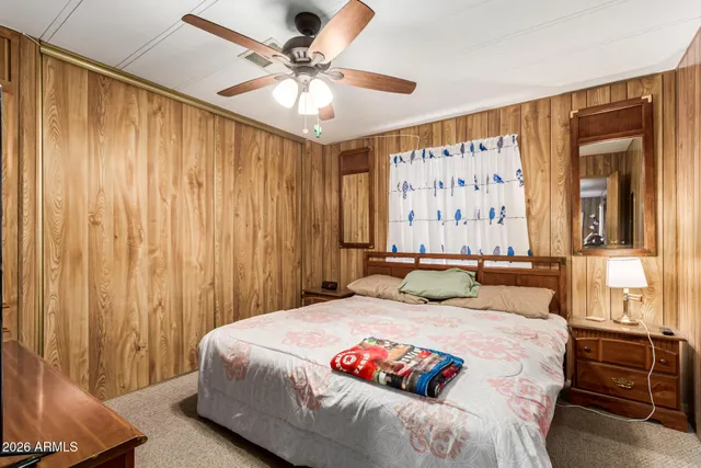 a bedroom with a large bed and a window