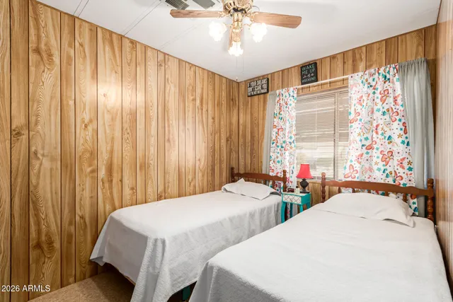 a bedroom with two beds and a chandelier