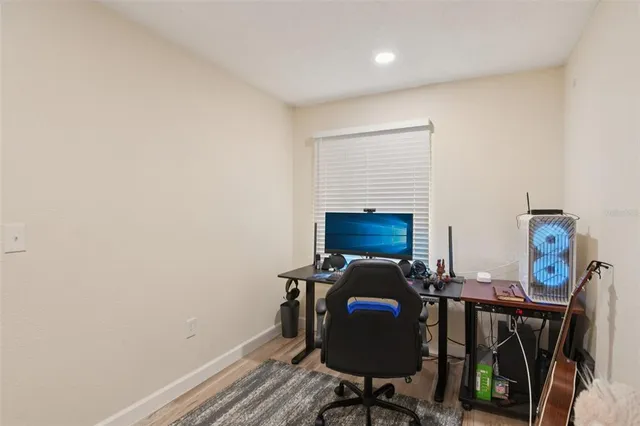 a view of a workspace with furniture and a fireplace