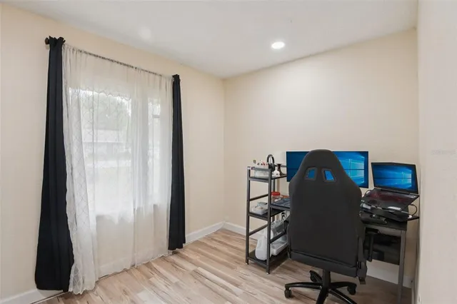 a view of a workspace with furniture and wooden floor