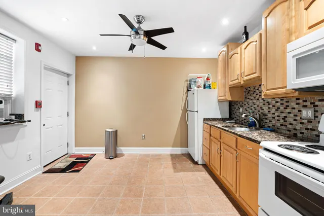 a kitchen with stainless steel appliances a refrigerator and a stove top oven