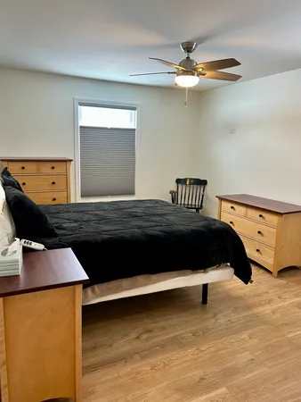 a bedroom with a bed and a ceiling fan