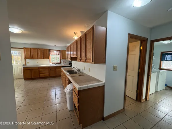 a kitchen with granite countertop a stove and a refrigerator