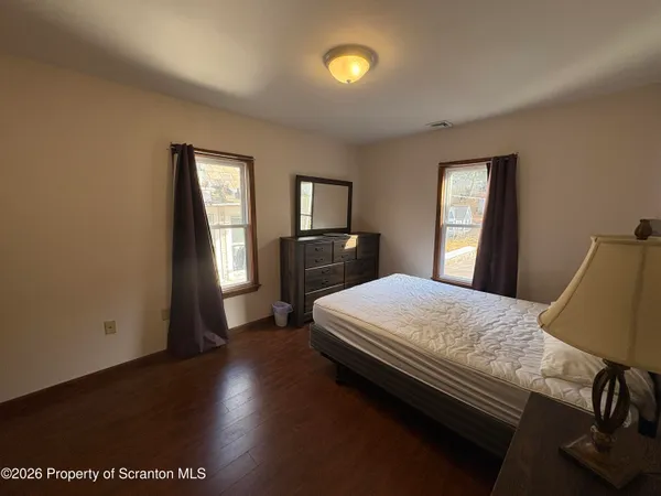 a bedroom with a bed and a chair