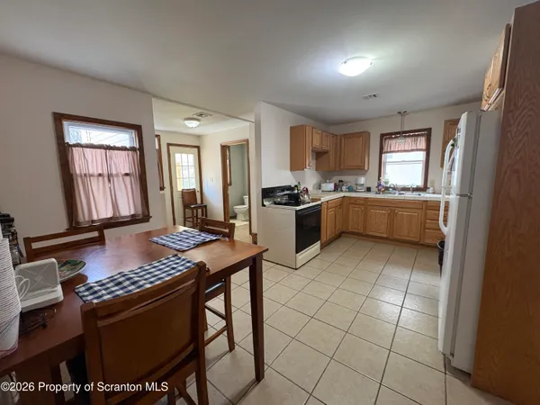 a kitchen with sink cabinets and stove top oven