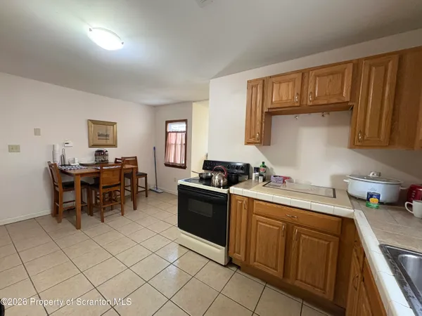 a kitchen with a cabinets and chairs