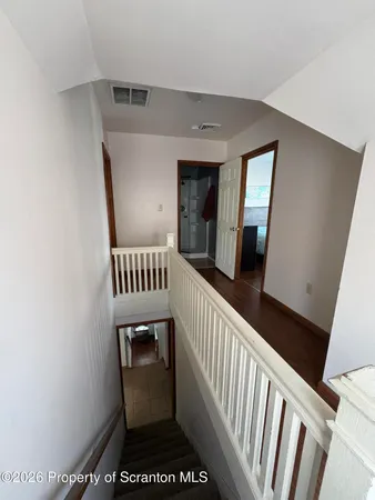 a view of a hallway with a white walls