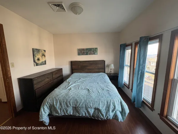 a bedroom with a bed and a large mirror