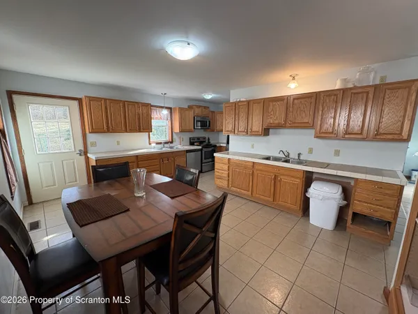 a kitchen with a sink a table and chairs