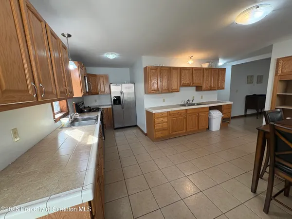 a large kitchen with a large counter top appliances and furniture