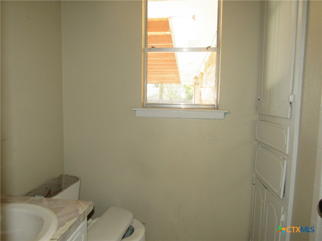 1325 Paseo Del Cobre Temple, TX 76502 - Photo 7 of 15 a white toilet sitting next to a window and a sink
