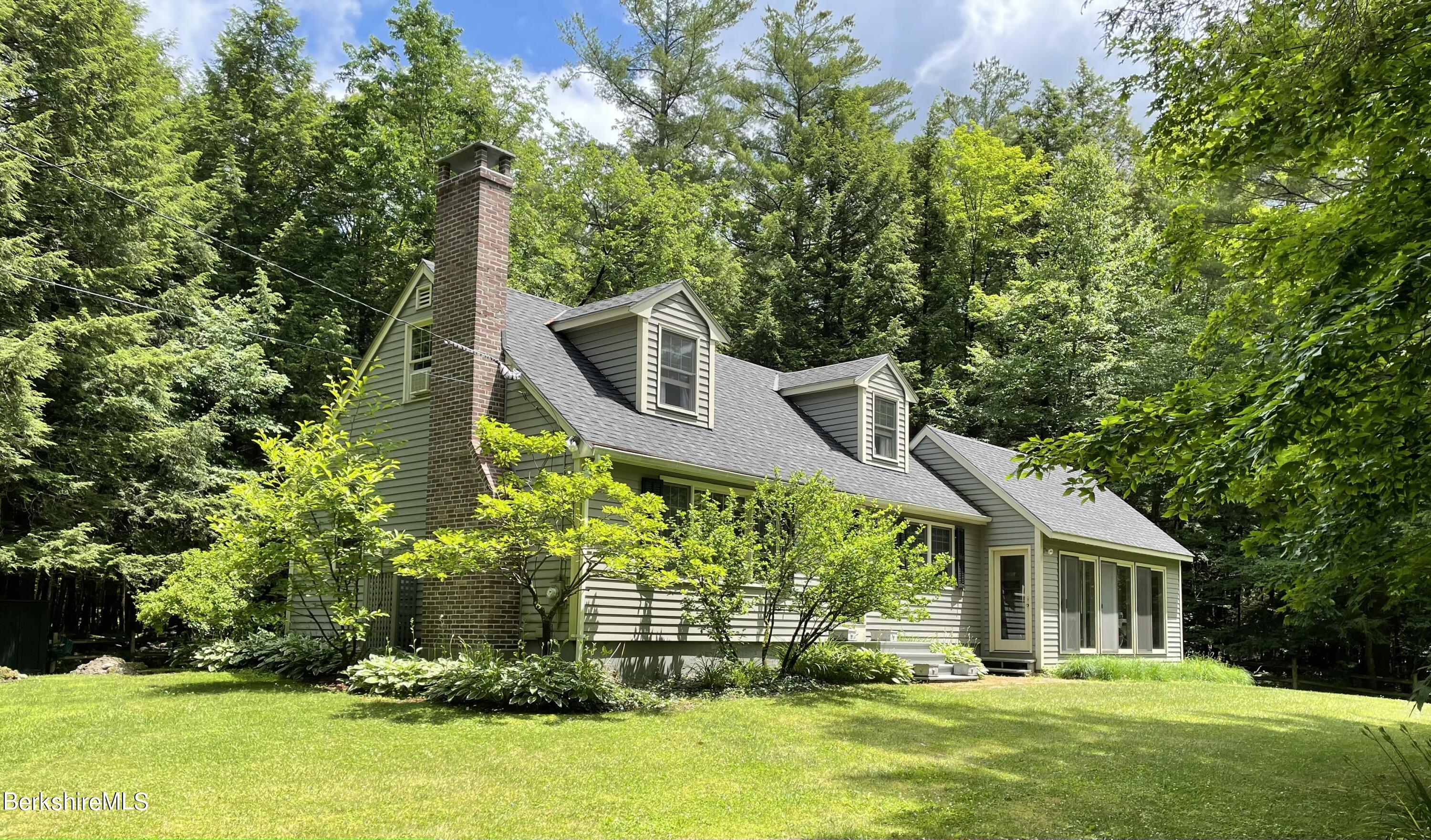 129 Main Road Tyringham, MA 01264 - Photo 1 of 1 a front view of a house with a yard