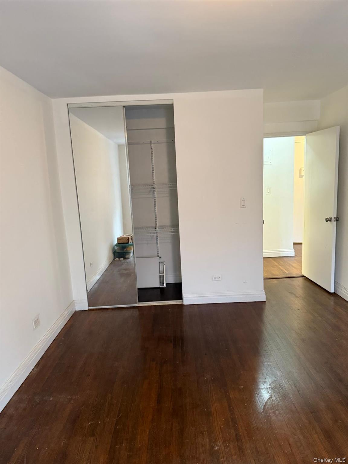 3520 Tryon Avenue, Unit 405 Bronx, NY 10467 - Photo 11 of 22 an empty room with wooden floor and entrance