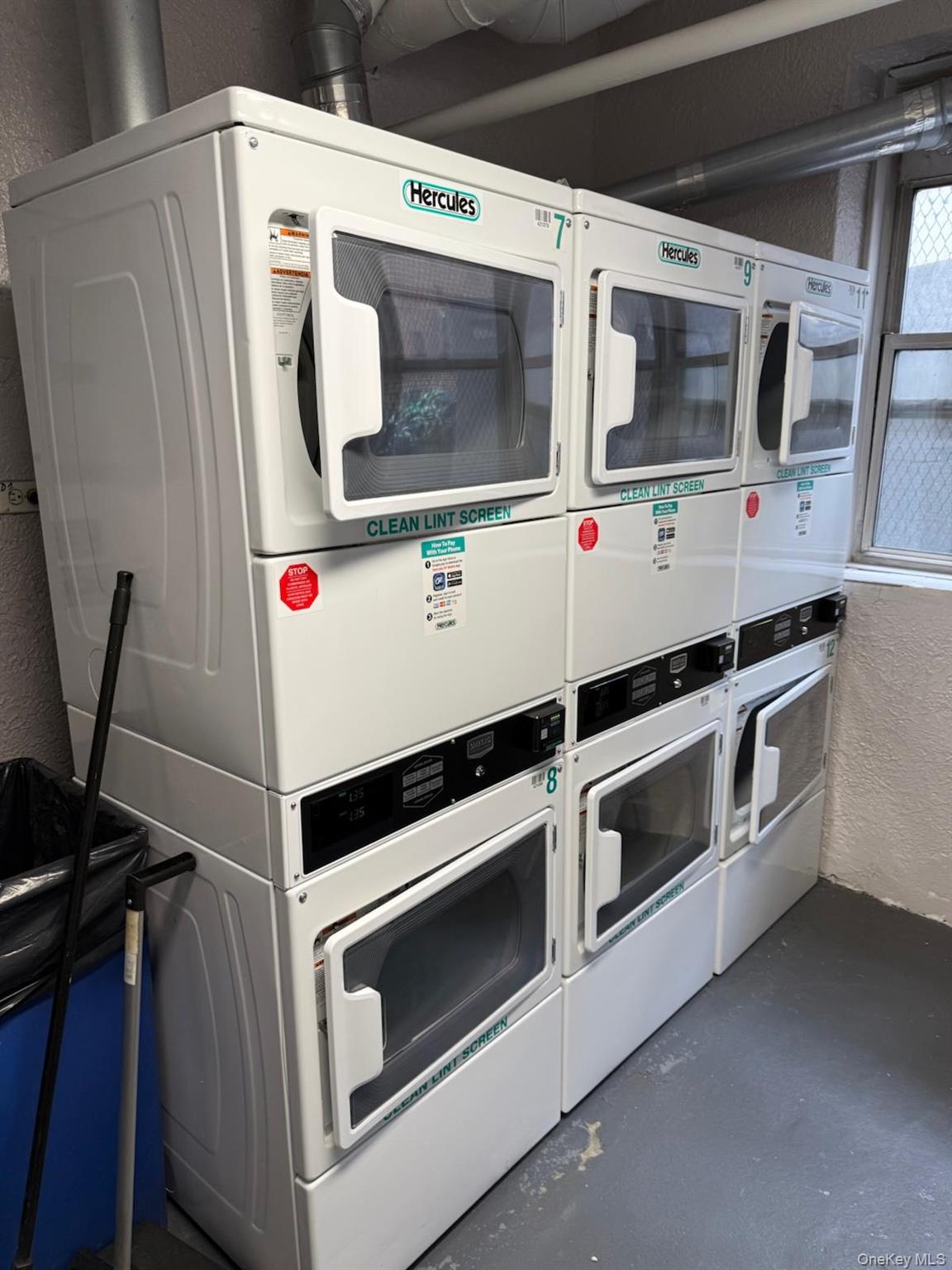 3520 Tryon Avenue, Unit 405 Bronx, NY 10467 - Photo 19 of 22 a utility room with stainless steel appliances and white walls