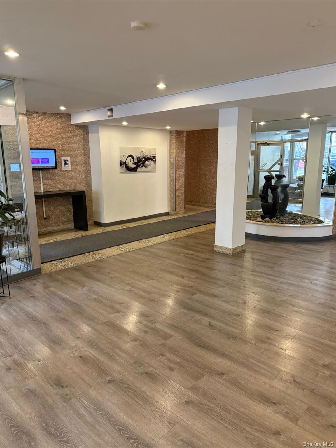 3520 Tryon Avenue, Unit 405 Bronx, NY 10467 - Photo 3 of 22 an empty room with wooden floor table and windows