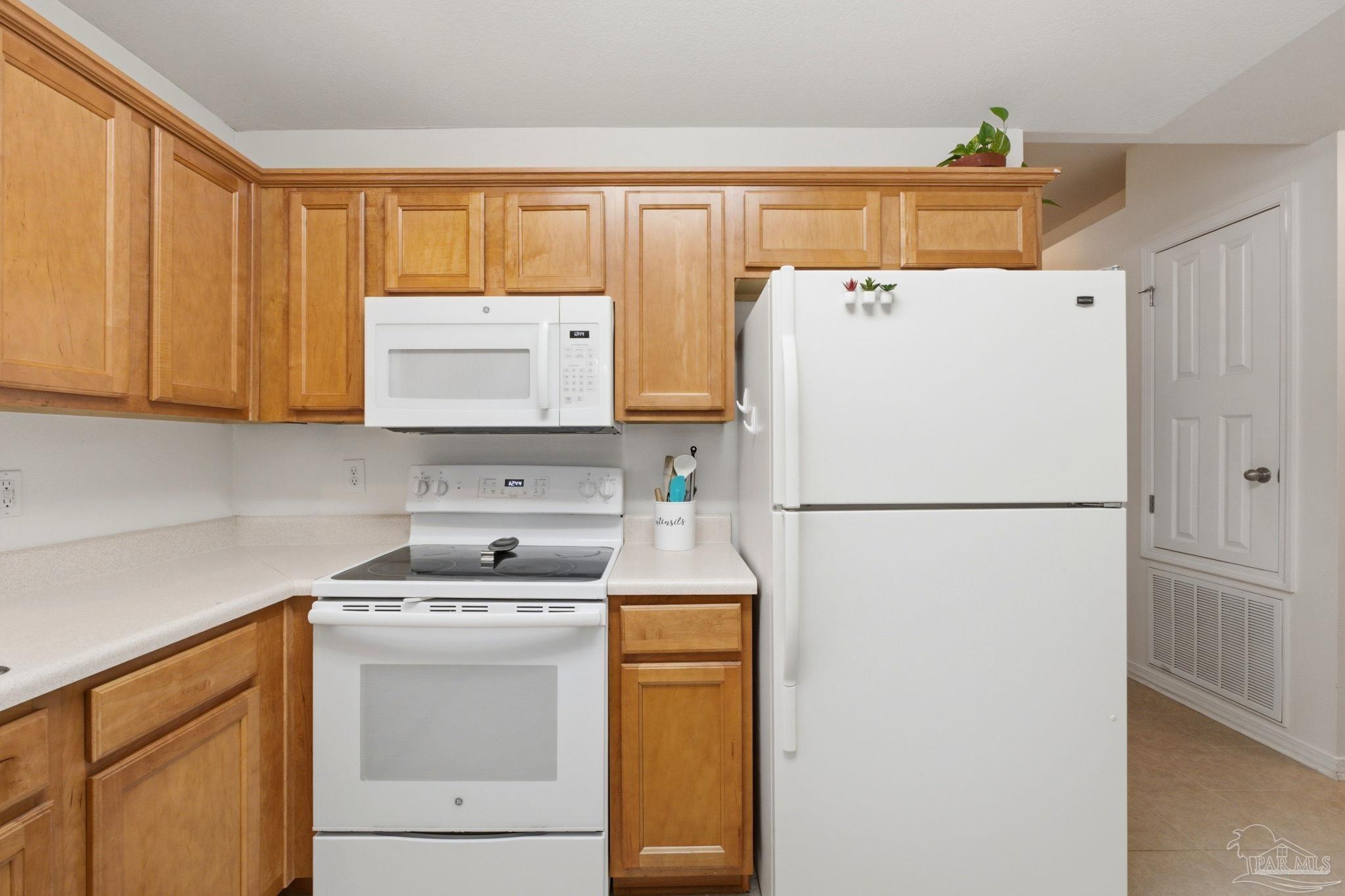 1237 Brownfield Road Pensacola, FL 32526 - Photo 11 of 30 a white refrigerator freezer and a stove sitting inside of a kitchen