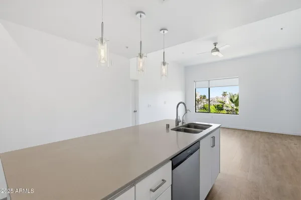 a kitchen with stainless steel appliances a sink a stove top oven a counter space and cabinets
