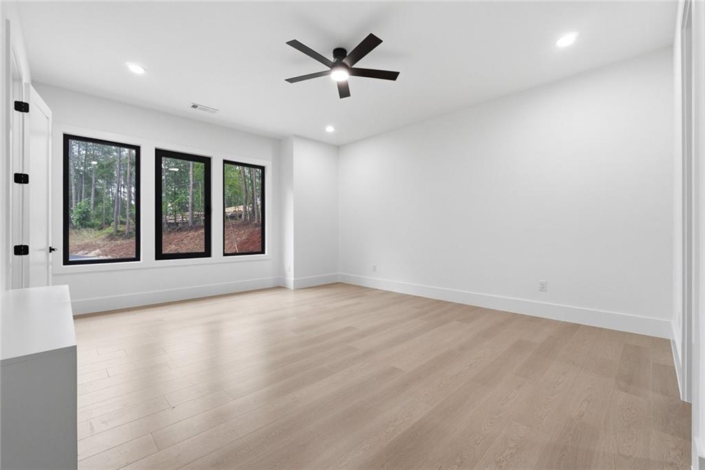 1563 Whitley Road Dacula, GA 30019 - Photo 26 of 44 an empty room with windows and ceiling fan