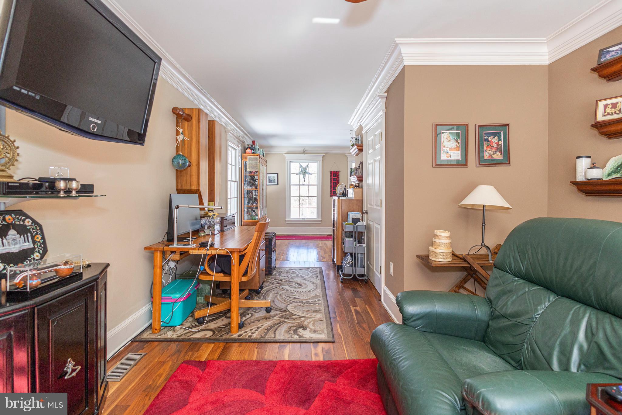 196 Aqueduct Road Washington Crossing, PA 18977 - Photo 15 of 57 a living room with furniture gym equipment and a flat screen tv