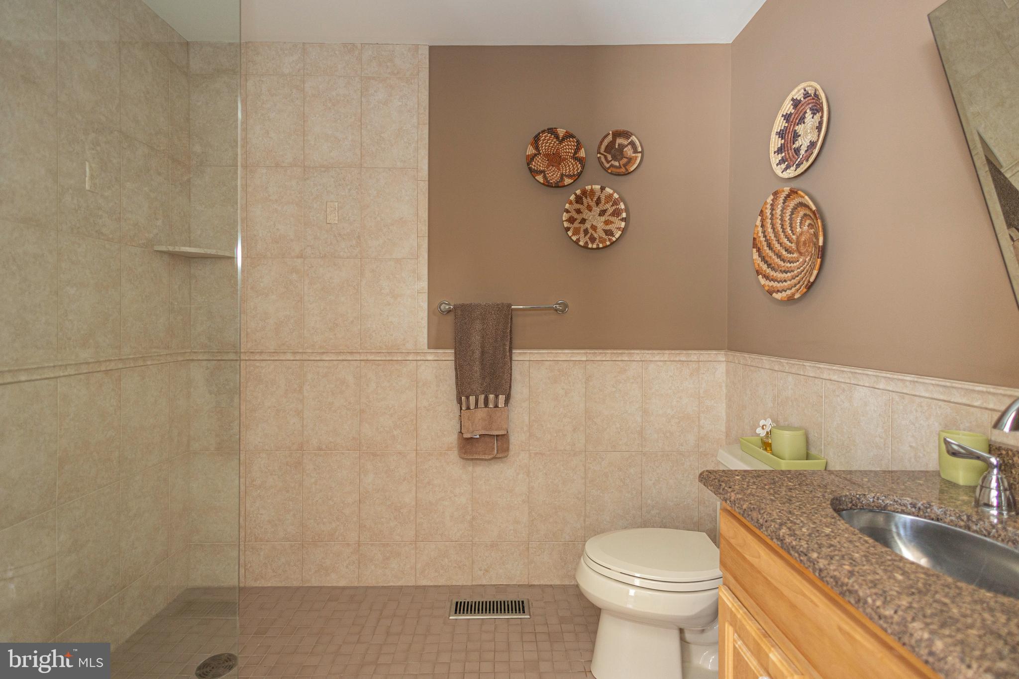 196 Aqueduct Road Washington Crossing, PA 18977 - Photo 16 of 57 a bathroom with a granite countertop toilet and a sink