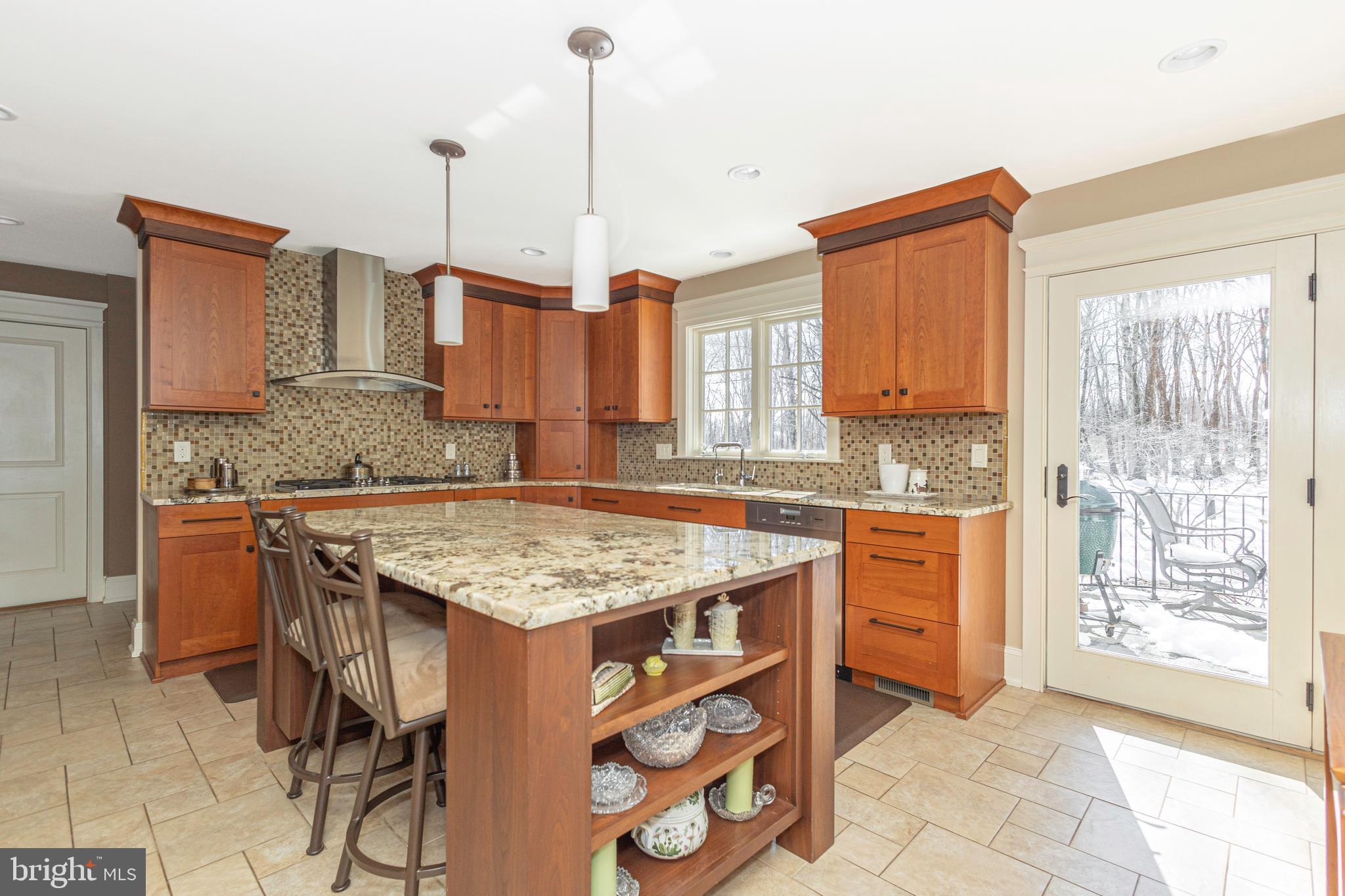196 Aqueduct Road Washington Crossing, PA 18977 - Photo 22 of 57 a kitchen with stainless steel appliances granite countertop a stove top oven a sink a counter space and cabinets