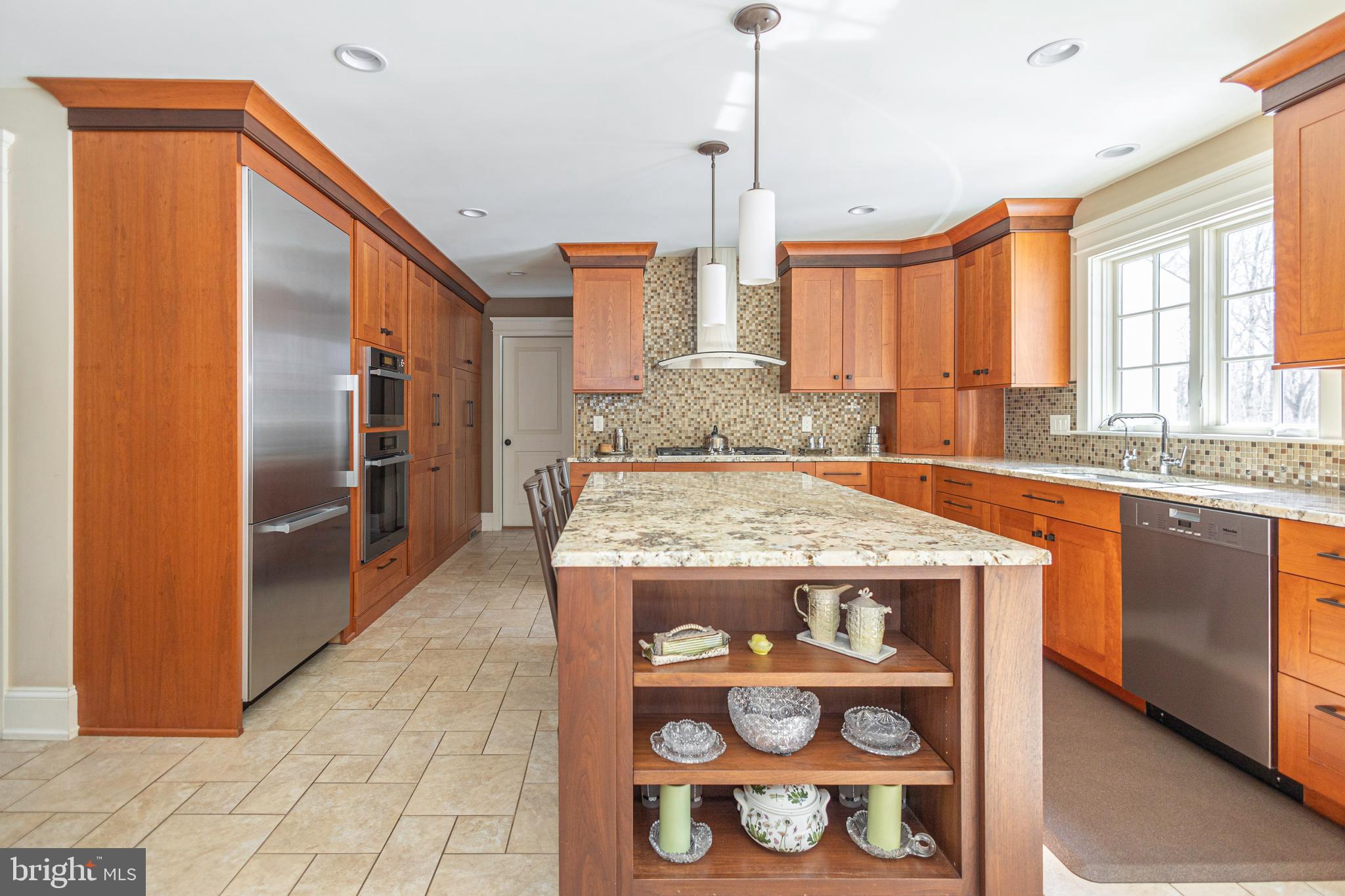 196 Aqueduct Road Washington Crossing, PA 18977 - Photo 23 of 57 a kitchen with kitchen island granite countertop a sink and a refrigerator