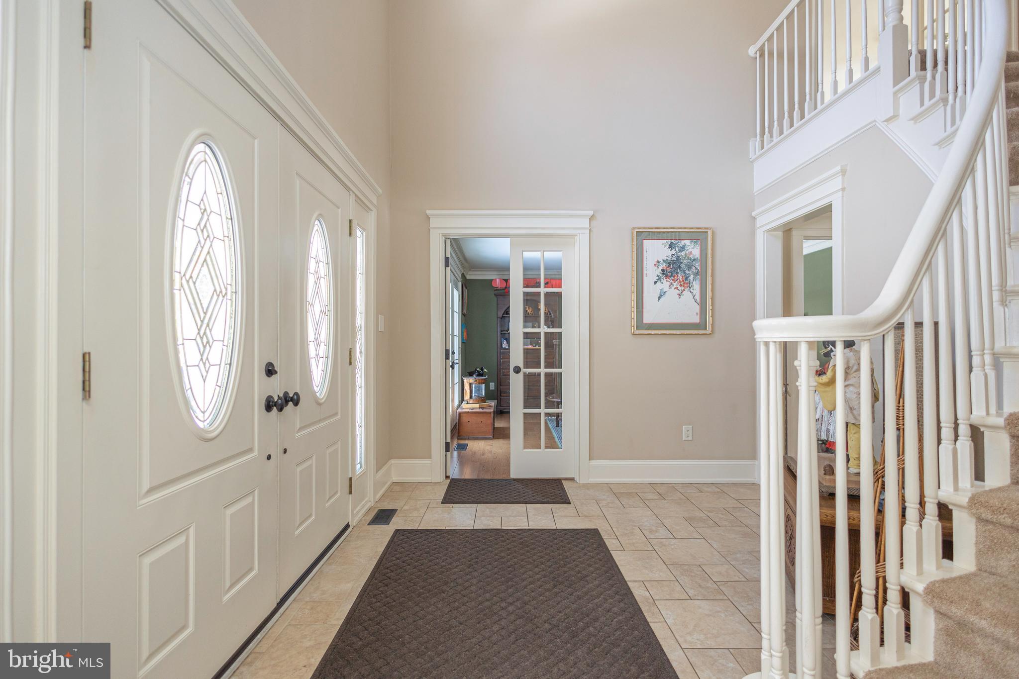 196 Aqueduct Road Washington Crossing, PA 18977 - Photo 4 of 57 a view of a hallway with windows and stairs