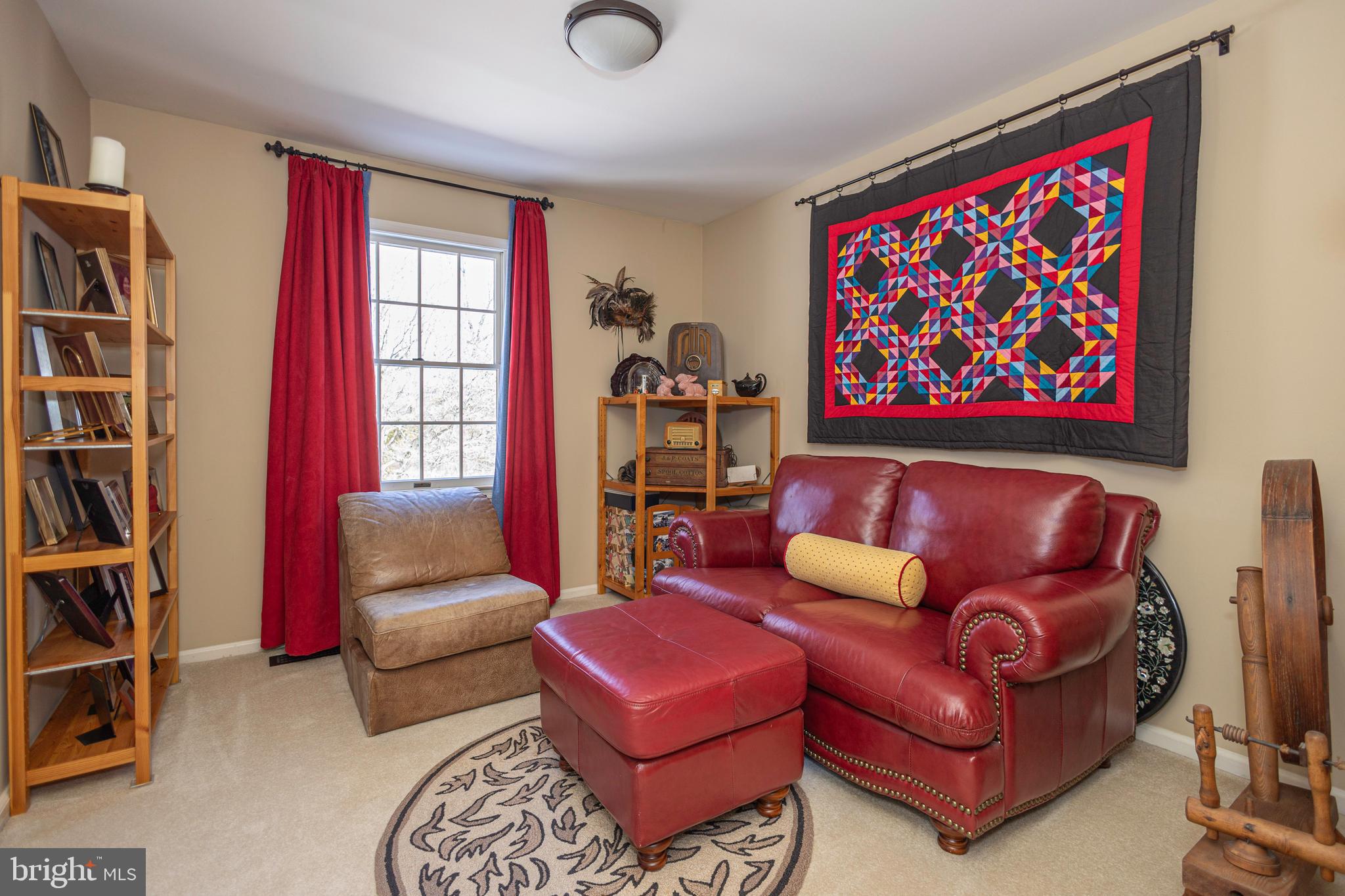196 Aqueduct Road Washington Crossing, PA 18977 - Photo 47 of 57 a blue couch sitting in a living room with a book shelf