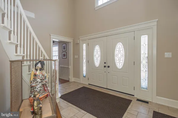 a view of an entryway with wooden floor and a livingroom view
