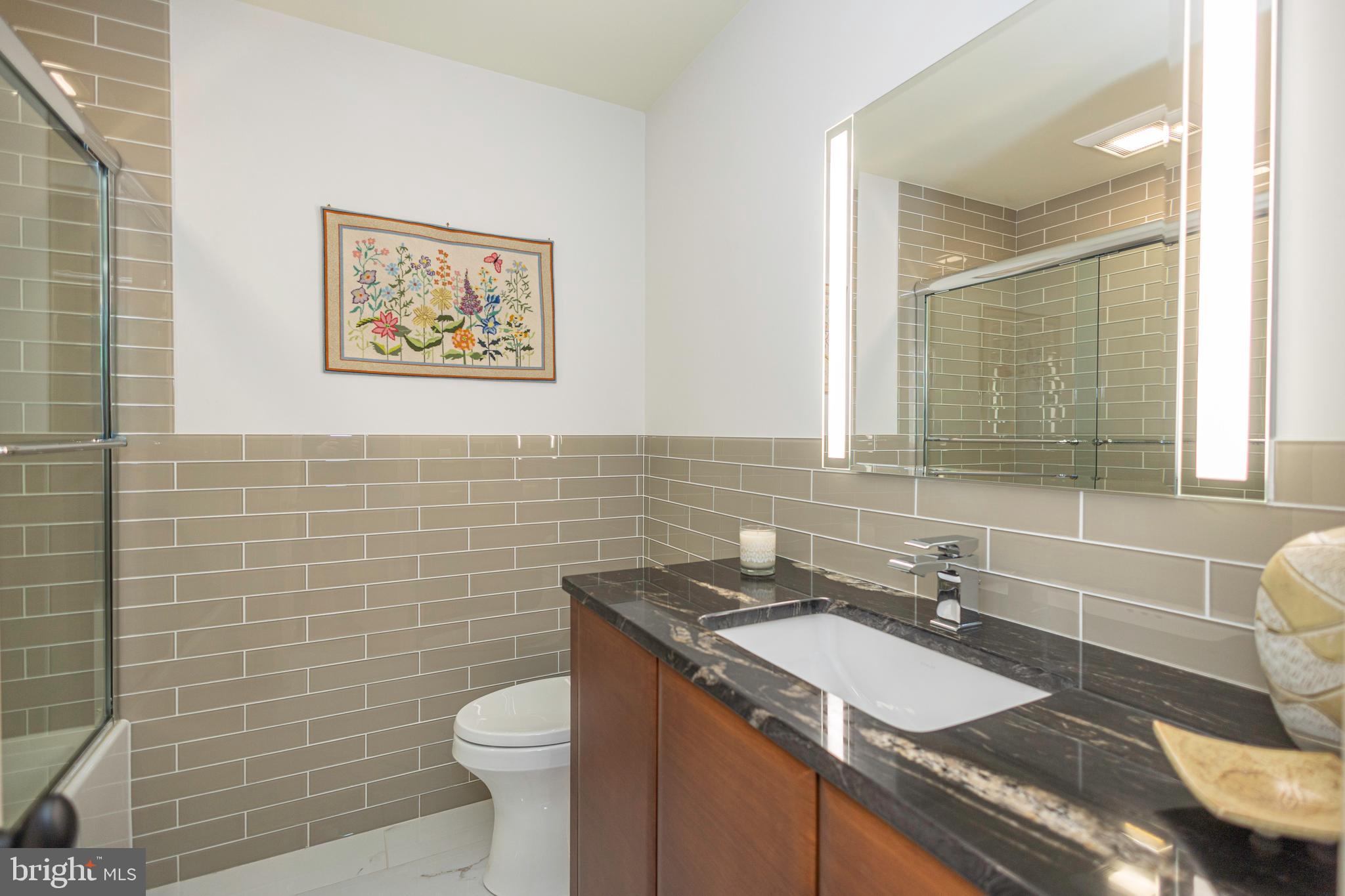 196 Aqueduct Road Washington Crossing, PA 18977 - Photo 52 of 57 a bathroom with a granite countertop toilet sink and mirror