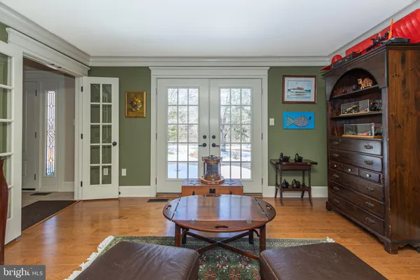 a living room with furniture a flat screen tv and a window