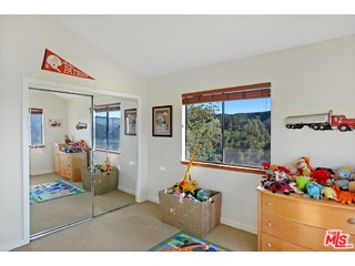 2717 Halsey Road Topanga, CA 90290 - Photo 16 of 39 a living room with furniture and a floor to ceiling window