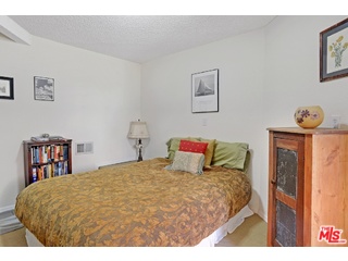 2717 Halsey Road Topanga, CA 90290 - Photo 18 of 39 a bedroom with a bed a table and painting on the wall