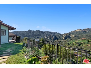 2717 Halsey Road Topanga, CA 90290 - Photo 28 of 39 a view of a lush green field with mountains in the background