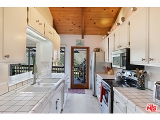 2717 Halsey Road Topanga, CA 90290 - Photo 31 of 39 a open kitchen with stainless steel appliances granite countertop a sink stove and refrigerator