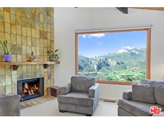 2717 Halsey Road Topanga, CA 90290 - Photo 37 of 39 a living room with furniture a large window and a fireplace