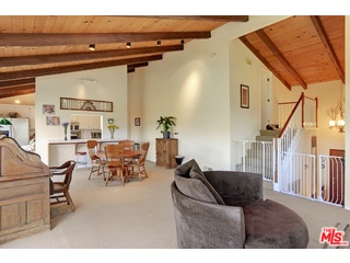2717 Halsey Road Topanga, CA 90290 - Photo 39 of 39 a living room with couches and a dining table with wooden floor