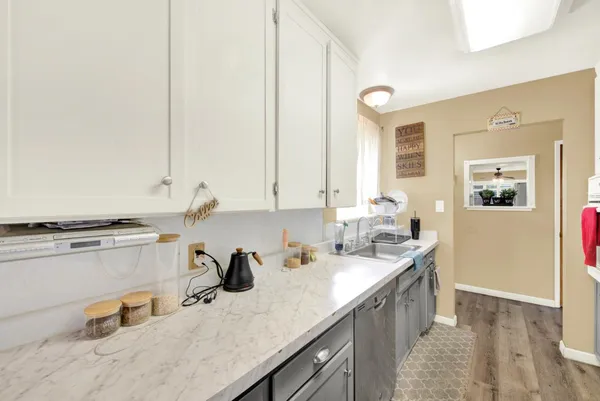 a kitchen with a sink cabinets and window