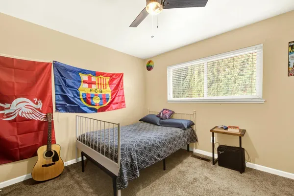 a bedroom with a bed and a window