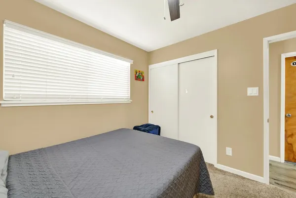 a bedroom with a bed and a window