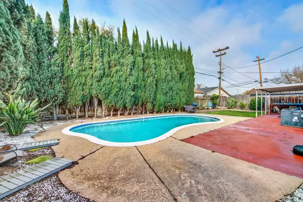 a view of a backyard with swimming pool