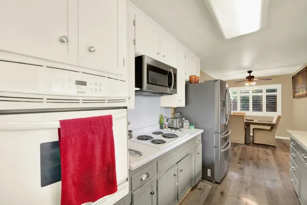 a kitchen with stainless steel appliances a stove microwave and cabinets