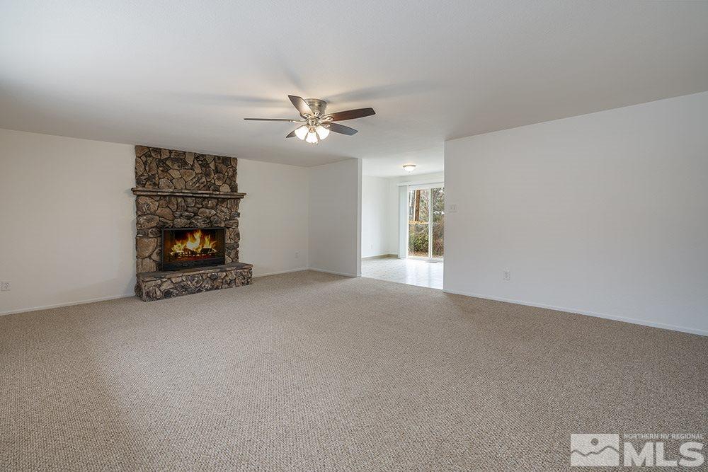 2235 Trentham Way Reno, NV 89509 - Photo 3 of 13 a view of an empty room with chandelier fan and fireplace
